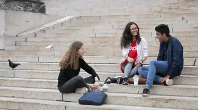 Trio of students on the steps of Low