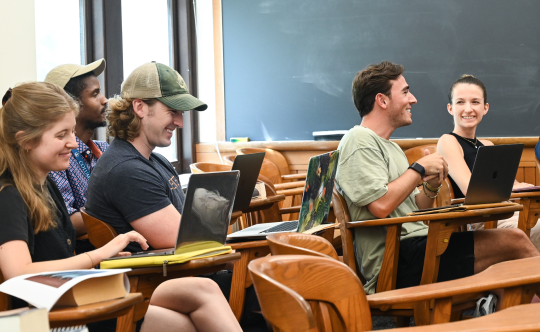 Pre-College students engaging in a lively conversation in a Columbia classroom.